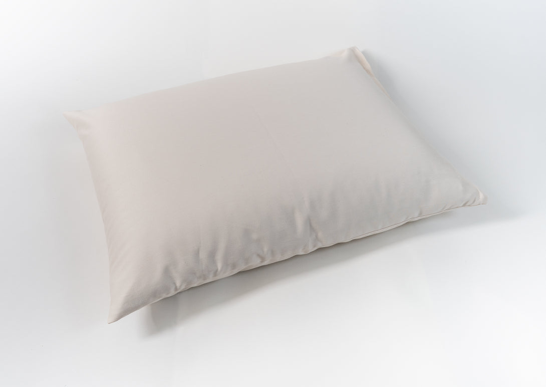 Natural wool pillow. Covered in a sateen fabric of organic cotton fibers.