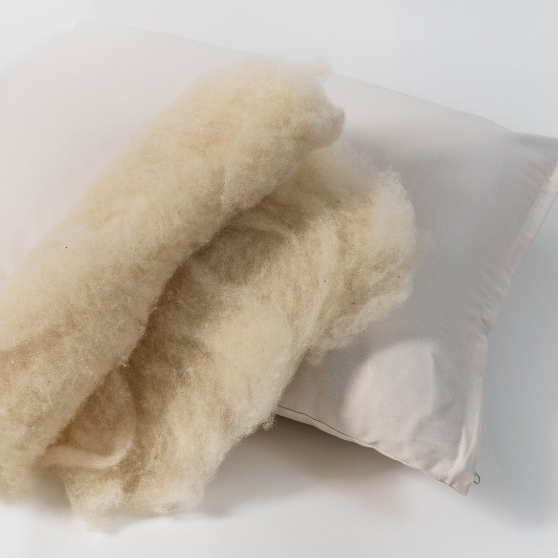 Natural wool pillow. Covered in a sateen fabric of organic cotton fibers.